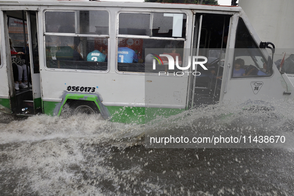 Public transport is circulating on Avenida Tlahuac in Mexico City after flooding is reported in various areas of the capital. 