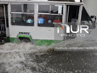 Public transport is circulating on Avenida Tlahuac in Mexico City after flooding is reported in various areas of the capital. (