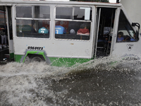 Public transport is circulating on Avenida Tlahuac in Mexico City after flooding is reported in various areas of the capital. (