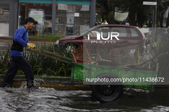 A person is trying to cross the street after flooding in various areas of Mexico City 