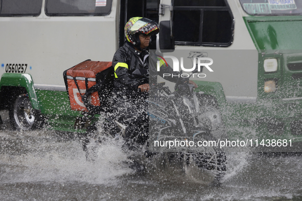 Motorcyclists are riding along Avenida Tlahuac in Mexico City after flooding is reported in various areas of the capital. 