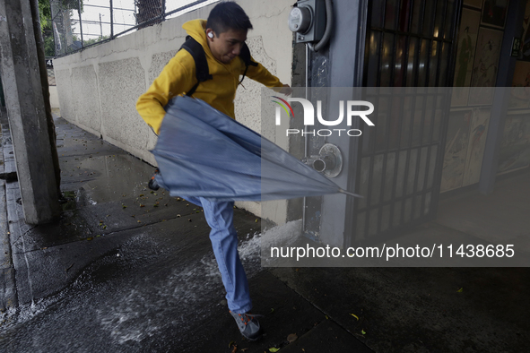 A person is trying to cross the street after flooding in various areas of Mexico City, Mexico. 