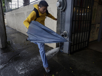 A person is trying to cross the street after flooding in various areas of Mexico City, Mexico. (