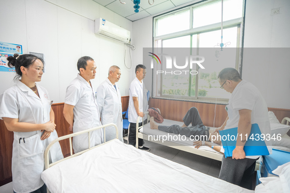 Doctors are exchanging cases at the Second People's Hospital of Jinsha County in Bijie, China, on July 17, 2024. 