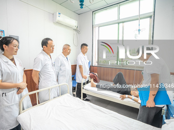 Doctors are exchanging cases at the Second People's Hospital of Jinsha County in Bijie, China, on July 17, 2024. (