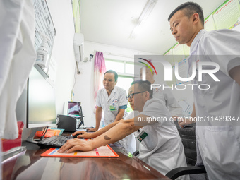 Doctors are exchanging cases at the Second People's Hospital of Jinsha County in Bijie, China, on July 17, 2024. (