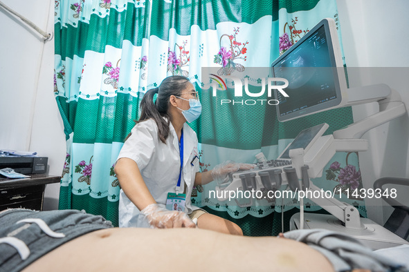 A doctor is using an instrument to treat a patient at the Second People's Hospital of Jinsha County in Bijie, China, on July 17, 2024. 