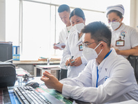 Doctors are exchanging cases at the Second People's Hospital of Jinsha County in Bijie, China, on July 17, 2024. (