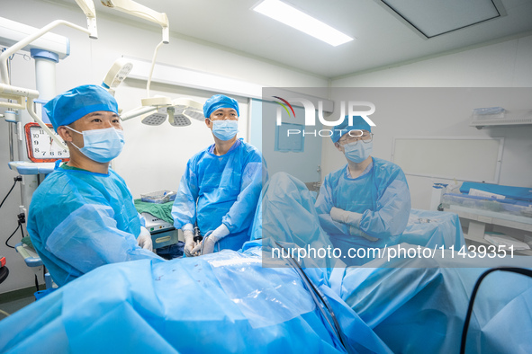 A doctor is performing laparoscopic lithotomy on a patient at the Second People's Hospital of Jinsha County in Bijie, China, on July 17, 202...