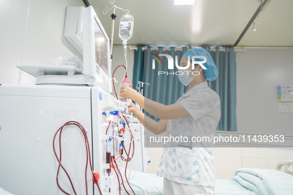 A doctor is performing hemodialysis treatment on a patient at the Second People's Hospital of Jinsha County in Bijie, China, on July 17, 202...