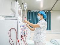 A doctor is performing hemodialysis treatment on a patient at the Second People's Hospital of Jinsha County in Bijie, China, on July 17, 202...