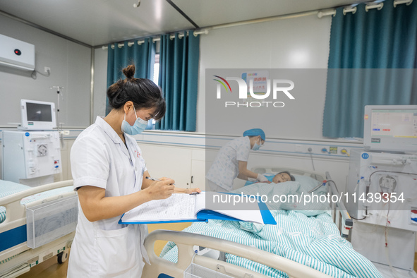 A doctor is performing hemodialysis treatment on a patient at the Second People's Hospital of Jinsha County in Bijie, China, on July 17, 202...