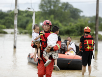 Rescue workers are moving trapped people in Jingtang village, Tangdong Subdistrict, Zixing city, Central China's Hunan province, on July 28,...