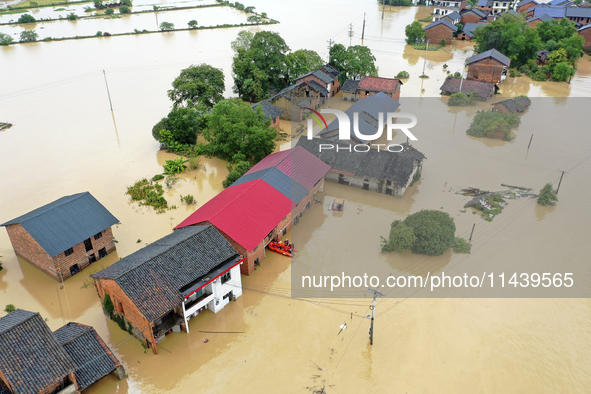 Rescue workers are moving trapped people in Jingtang village, Tangdong Subdistrict, Zixing city, Central China's Hunan province, on July 28,...