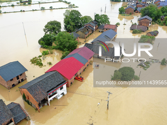 Rescue workers are moving trapped people in Jingtang village, Tangdong Subdistrict, Zixing city, Central China's Hunan province, on July 28,...