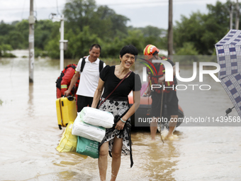 Rescue workers are moving trapped people in Jingtang village, Tangdong Subdistrict, Zixing city, Central China's Hunan province, on July 28,...