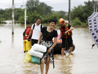 Rescue workers are moving trapped people in Jingtang village, Tangdong Subdistrict, Zixing city, Central China's Hunan province, on July 28,...