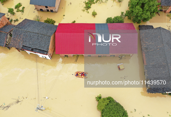 Rescue workers are moving trapped people in Jingtang village, Tangdong Subdistrict, Zixing city, Central China's Hunan province, on July 28,...