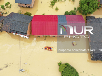 Rescue workers are moving trapped people in Jingtang village, Tangdong Subdistrict, Zixing city, Central China's Hunan province, on July 28,...