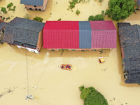 Rescue workers are moving trapped people in Jingtang village, Tangdong Subdistrict, Zixing city, Central China's Hunan province, on July 28,...