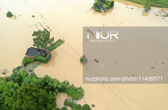 Rescue workers are moving trapped people in Jingtang village, Tangdong Subdistrict, Zixing city, Central China's Hunan province, on July 28,...