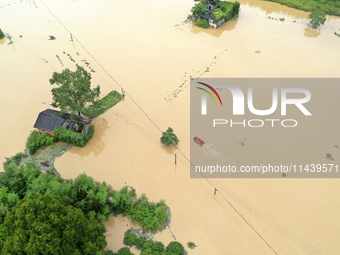 Rescue workers are moving trapped people in Jingtang village, Tangdong Subdistrict, Zixing city, Central China's Hunan province, on July 28,...