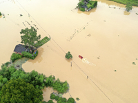 Rescue workers are moving trapped people in Jingtang village, Tangdong Subdistrict, Zixing city, Central China's Hunan province, on July 28,...