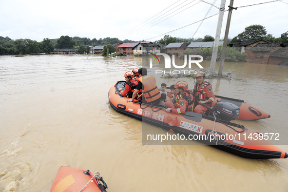 Rescue workers are moving trapped people in Jingtang village, Tangdong Subdistrict, Zixing city, Central China's Hunan province, on July 28,...