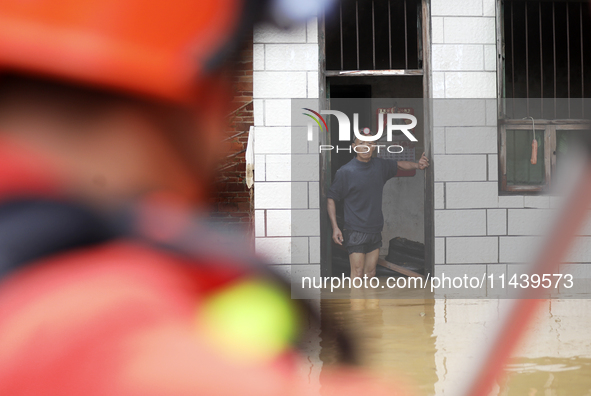 Rescue workers are moving trapped people in Jingtang village, Tangdong Subdistrict, Zixing city, Central China's Hunan province, on July 28,...