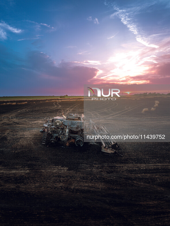 A combine is sparking a devastating fire in a wheat field in Orangeville, IL, rapidly spreading and engulfing a significant portion of the c...