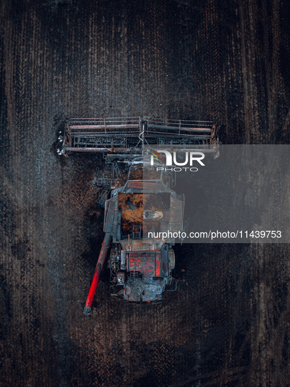 A combine is sparking a devastating fire in a wheat field in Orangeville, IL, rapidly spreading and engulfing a significant portion of the c...