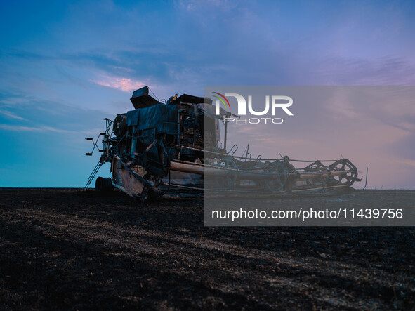 A combine is sparking a devastating fire in a wheat field in Orangeville, IL, rapidly spreading and engulfing a significant portion of the c...