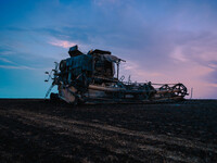 A combine is sparking a devastating fire in a wheat field in Orangeville, IL, rapidly spreading and engulfing a significant portion of the c...