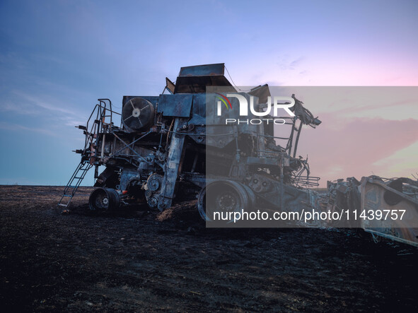 A combine is sparking a devastating fire in a wheat field in Orangeville, IL, rapidly spreading and engulfing a significant portion of the c...