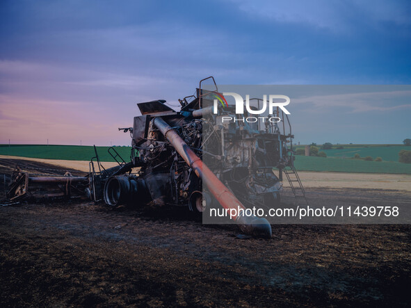 A combine is sparking a devastating fire in a wheat field in Orangeville, IL, rapidly spreading and engulfing a significant portion of the c...