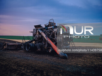 A combine is sparking a devastating fire in a wheat field in Orangeville, IL, rapidly spreading and engulfing a significant portion of the c...