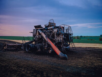 A combine is sparking a devastating fire in a wheat field in Orangeville, IL, rapidly spreading and engulfing a significant portion of the c...