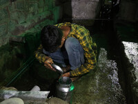 A boy is filling a steel bucket with water on a hot summer evening in Srinagar, Jammu and Kashmir, on July 28, 2024. Kashmir is reeling unde...