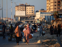 Displaced Palestinians are leaving al-Bureij refugee camp towards the west, after the Israeli army issued a new evacuation order, in the cen...