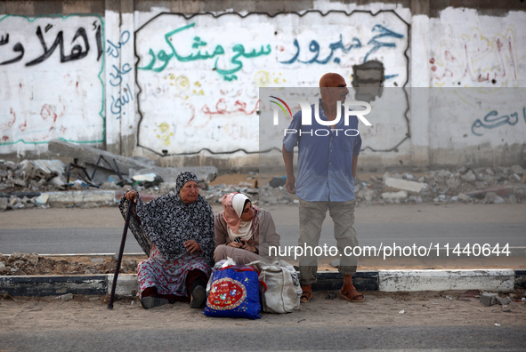 Displaced Palestinians are leaving al-Bureij refugee camp towards the west, after the Israeli army issued a new evacuation order, in the cen...