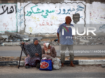 Displaced Palestinians are leaving al-Bureij refugee camp towards the west, after the Israeli army issued a new evacuation order, in the cen...