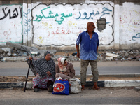 Displaced Palestinians are leaving al-Bureij refugee camp towards the west, after the Israeli army issued a new evacuation order, in the cen...