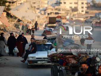 Displaced Palestinians are leaving al-Bureij refugee camp towards the west, after the Israeli army issued a new evacuation order, in the cen...