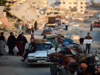 Displaced Palestinians are leaving al-Bureij refugee camp towards the west, after the Israeli army issued a new evacuation order, in the cen...