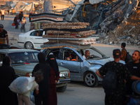 Displaced Palestinians are leaving al-Bureij refugee camp towards the west, after the Israeli army issued a new evacuation order, in the cen...