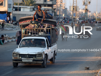 Displaced Palestinians are leaving al-Bureij refugee camp towards the west, after the Israeli army issued a new evacuation order, in the cen...