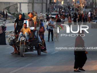 Displaced Palestinians are leaving al-Bureij refugee camp towards the west, after the Israeli army issued a new evacuation order, in the cen...