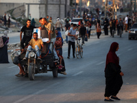 Displaced Palestinians are leaving al-Bureij refugee camp towards the west, after the Israeli army issued a new evacuation order, in the cen...