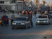 Displaced Palestinians are leaving al-Bureij refugee camp towards the west, after the Israeli army issued a new evacuation order, in the cen...