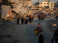 Displaced Palestinians are leaving al-Bureij refugee camp towards the west, after the Israeli army issued a new evacuation order, in the cen...